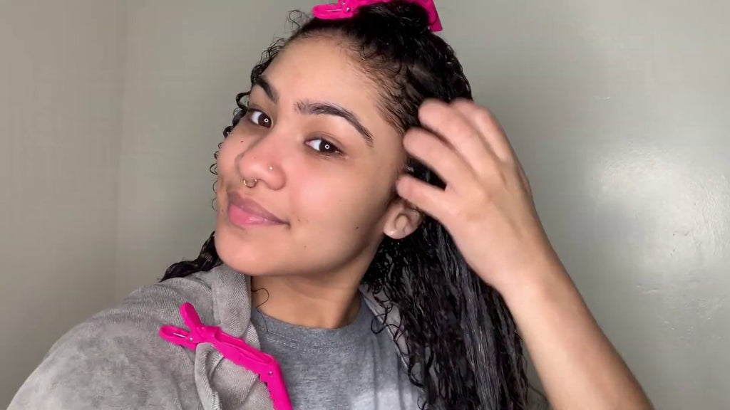 Woman brushing hair with fingertips